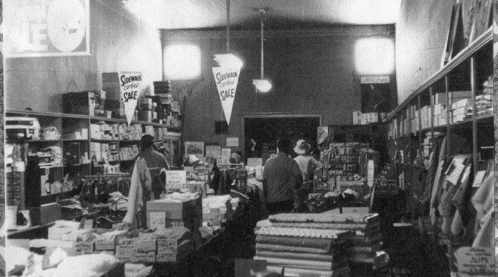 The interior of Wohler’s Dry Goods store, taken during a “Sidewalk Sale”, circ. 1965. Clothing, shoes, fabric flats, and shoppers are seen. Western Sonoma County Historical Society photo collection.